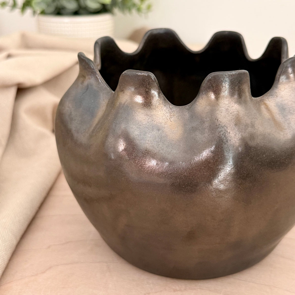 Close up detail of hand-altered ruffle rim on stoneware vase